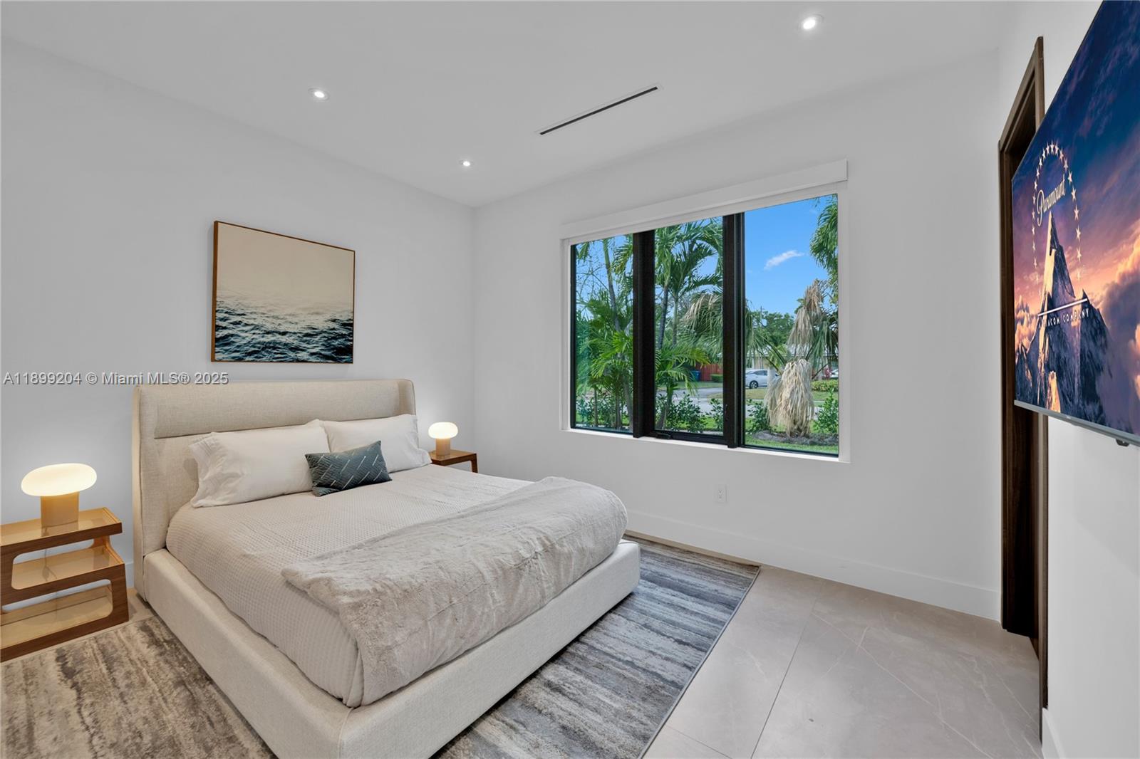 2110 Northeast 197th Terrace Miami, FL 33179 - Photo 51 of 77 a bedroom with a bed and a painting on the wall