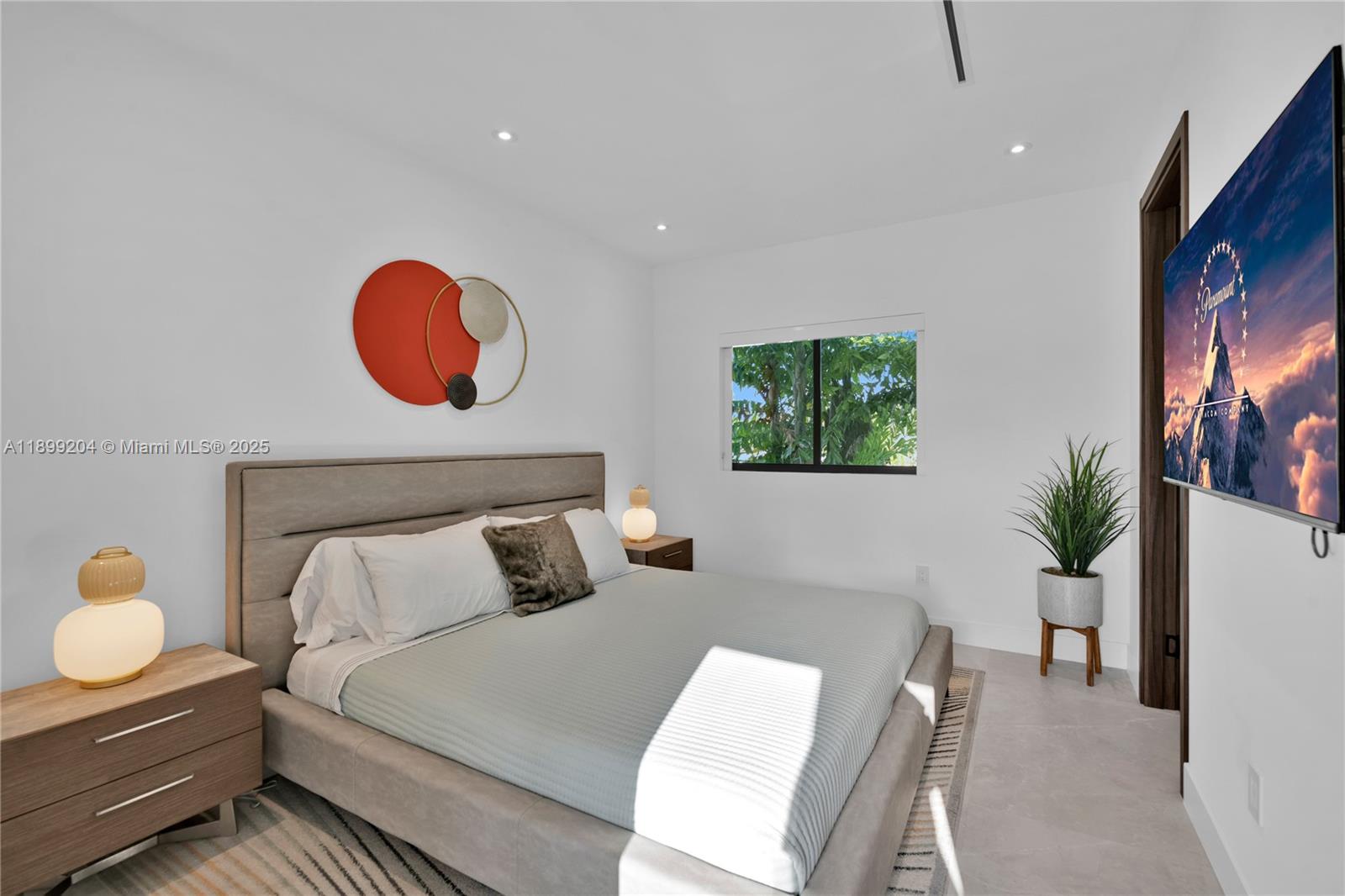 2110 Northeast 197th Terrace Miami, FL 33179 - Photo 55 of 77 a bedroom with a bed and window