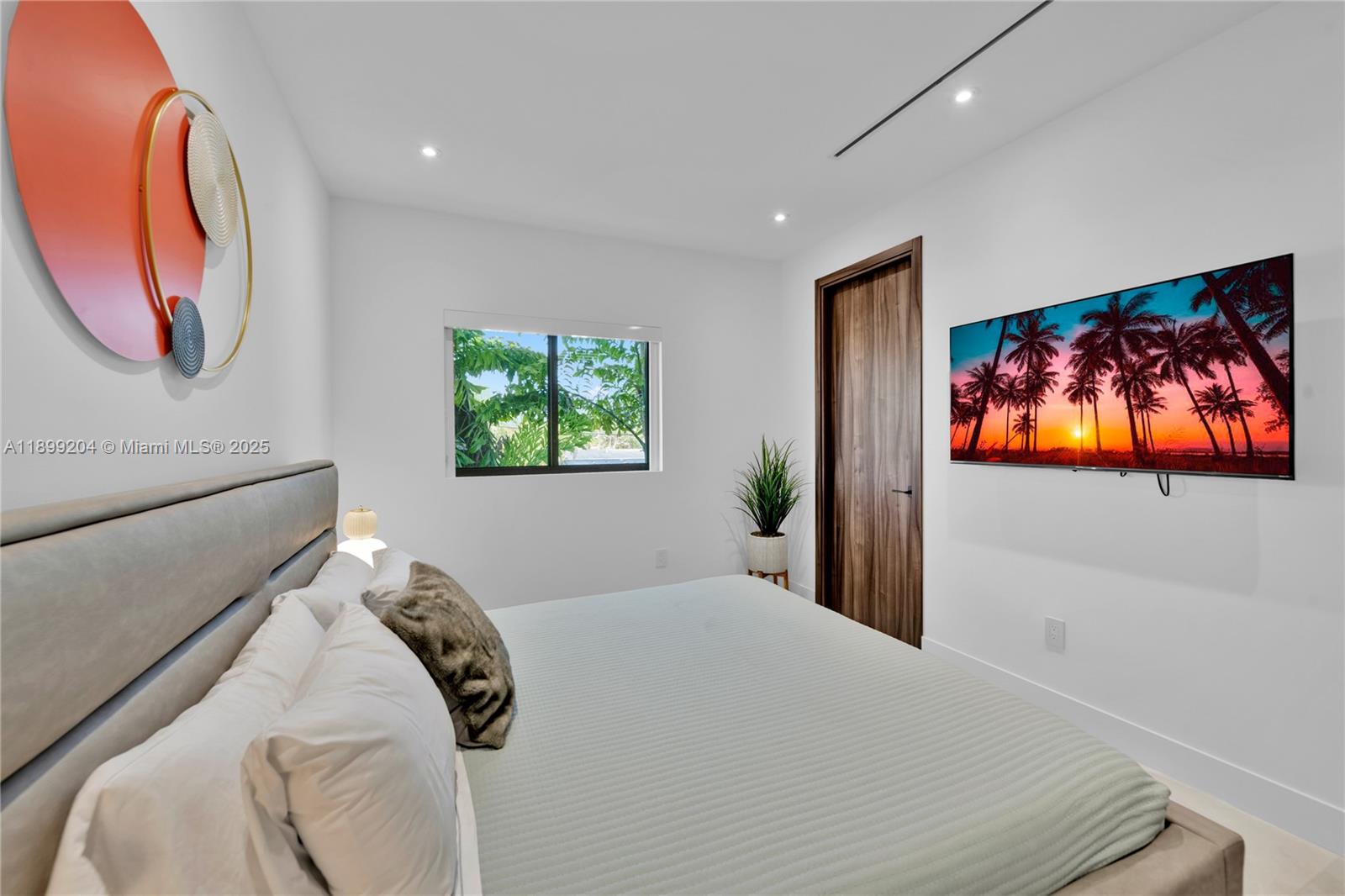 2110 Northeast 197th Terrace Miami, FL 33179 - Photo 56 of 77 a bedroom with a bed and a painting on the wall