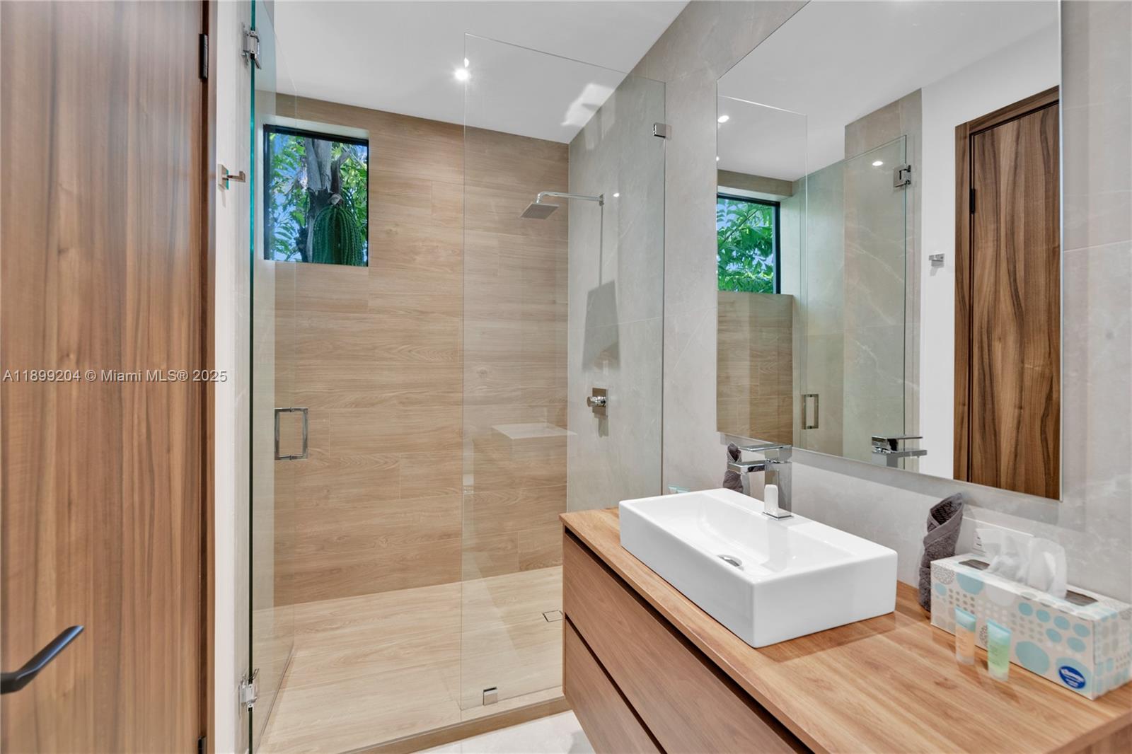 2110 Northeast 197th Terrace Miami, FL 33179 - Photo 57 of 77 a bathroom with a sink a shower and a mirror