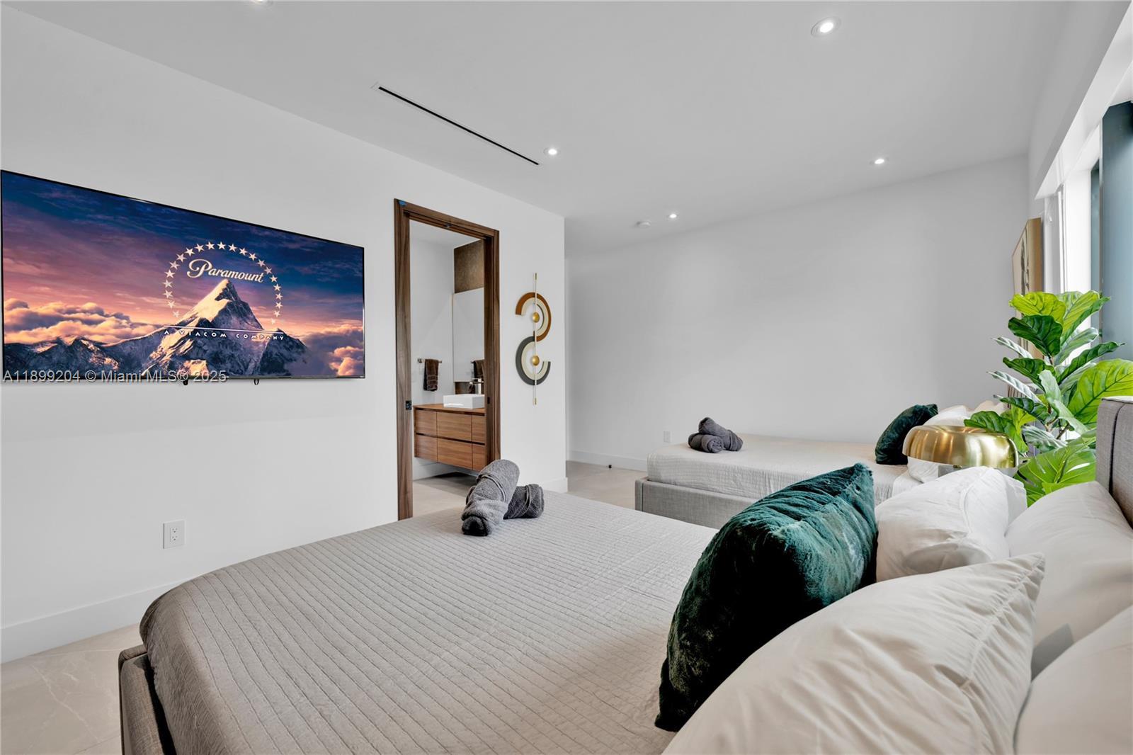 2110 Northeast 197th Terrace Miami, FL 33179 - Photo 65 of 77 a bedroom with a bed and a painting on the wall