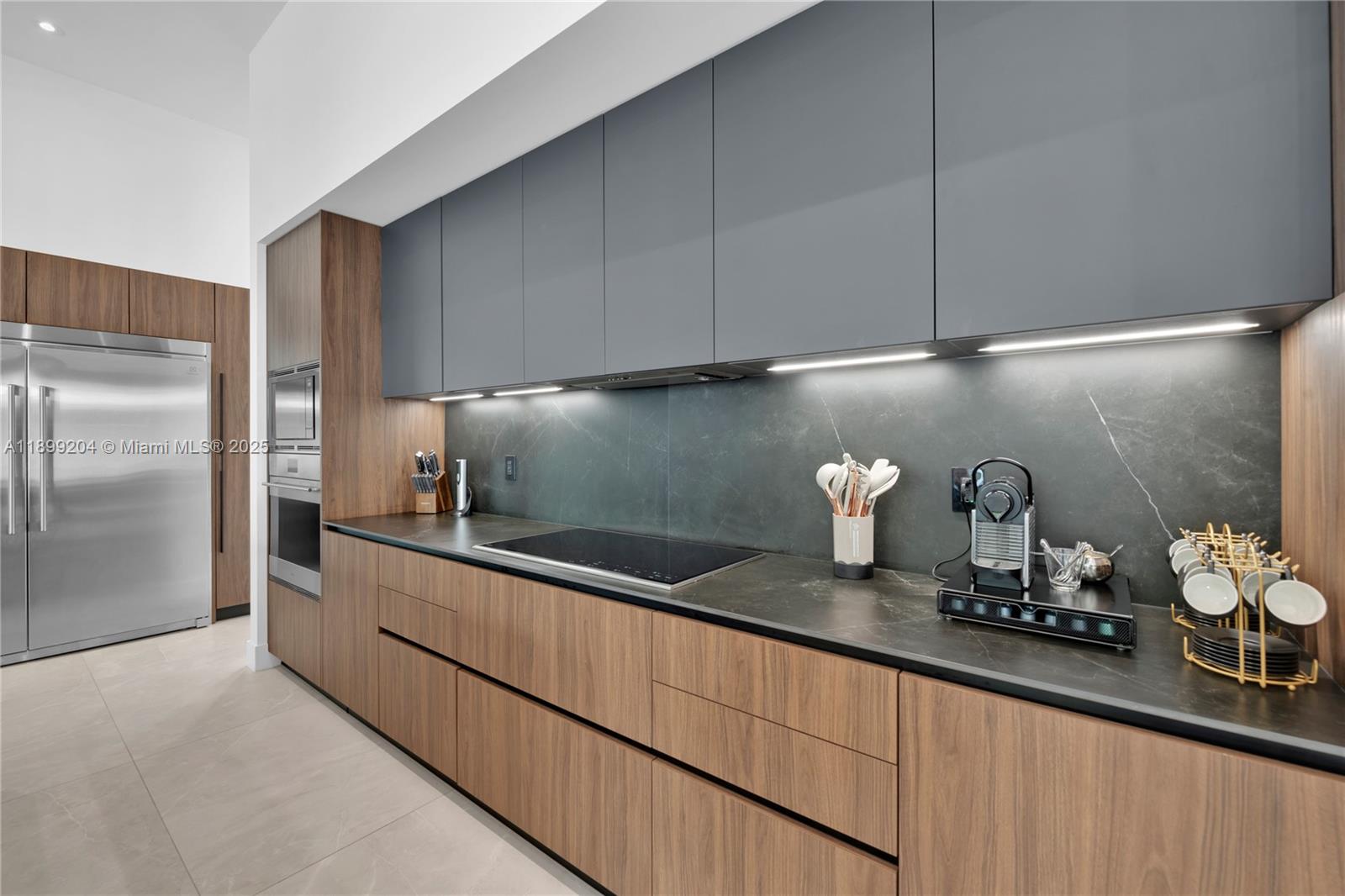 2110 Northeast 197th Terrace Miami, FL 33179 - Photo 66 of 77 a kitchen with granite countertop white cabinets and stainless steel appliances