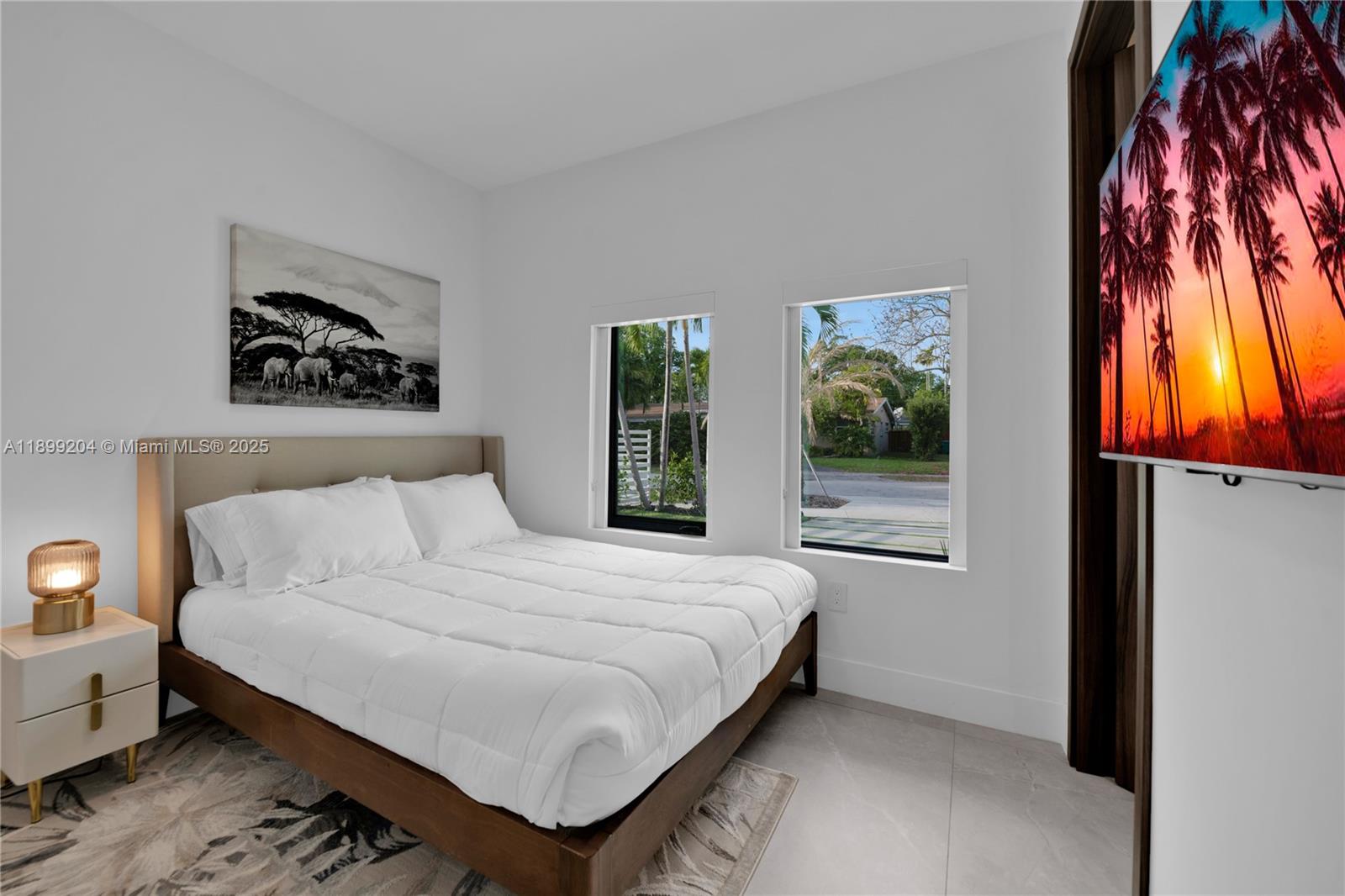 2110 Northeast 197th Terrace Miami, FL 33179 - Photo 67 of 77 a bedroom with a bed and a window