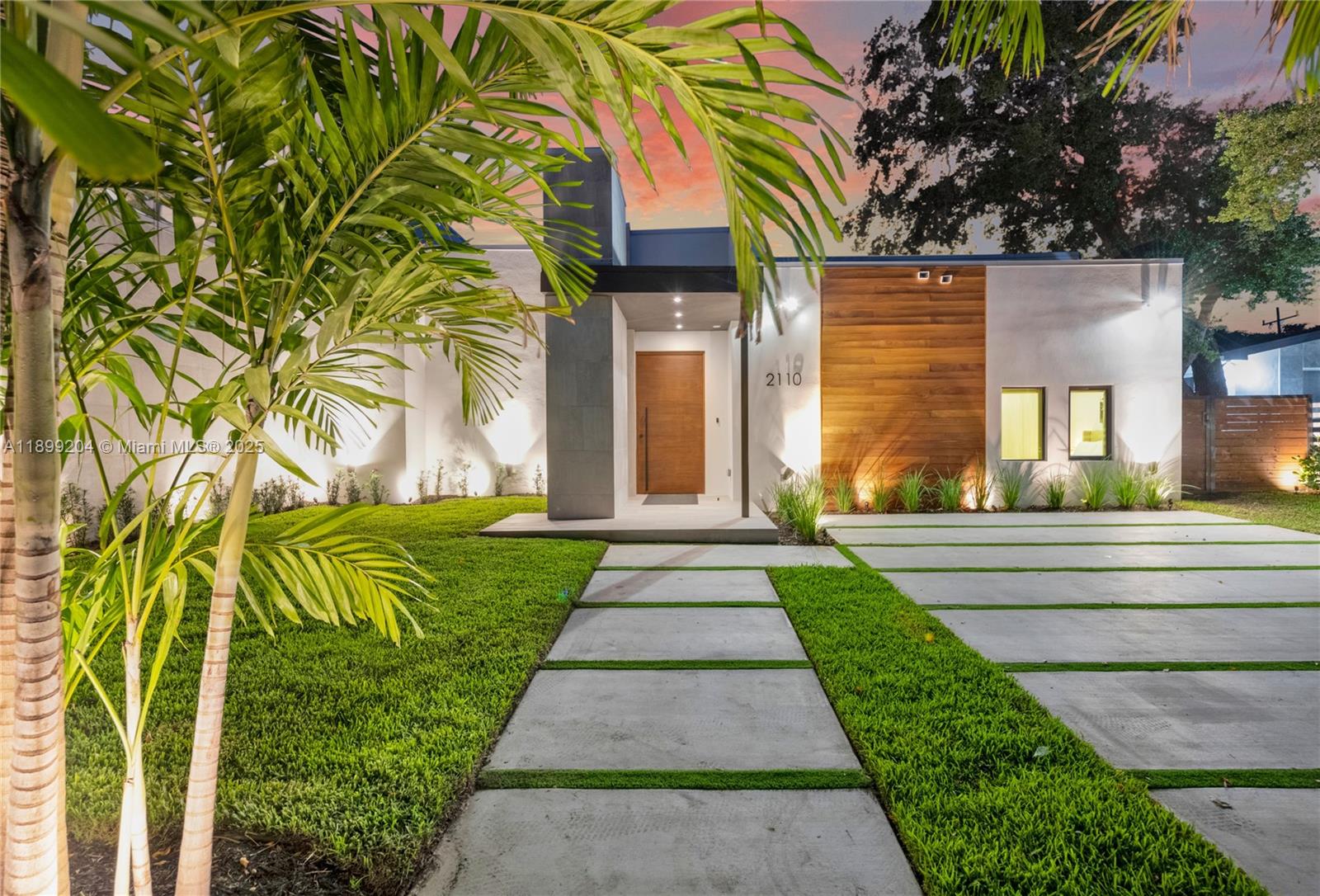 2110 Northeast 197th Terrace Miami, FL 33179 - Photo 70 of 77 a front view of a house with a garden