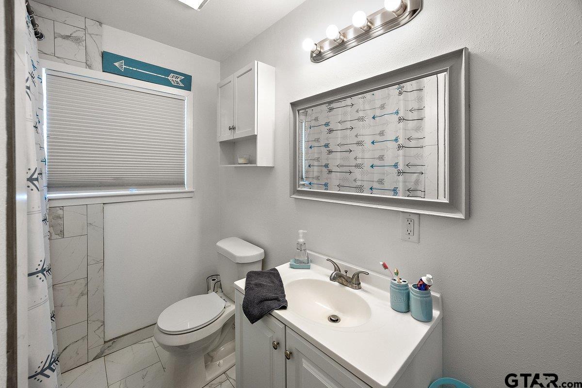 279 Fairview Street Rusk, TX 75785 - Photo 12 of 23 a bathroom with a sink toilet and shower