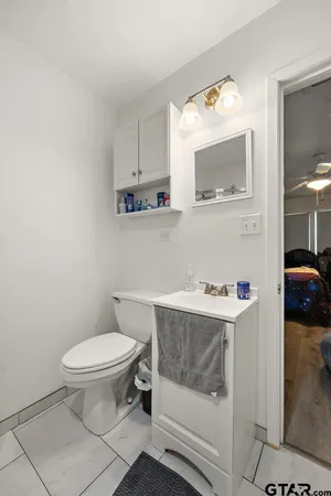 a bathroom with a toilet a sink and mirror