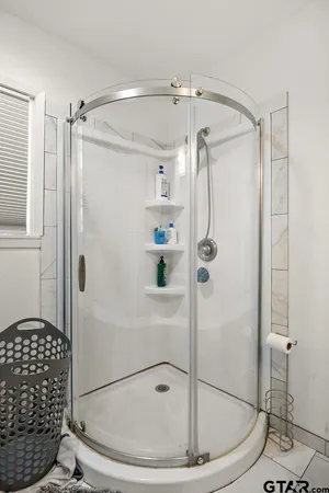 a bathroom that has a glass shower door