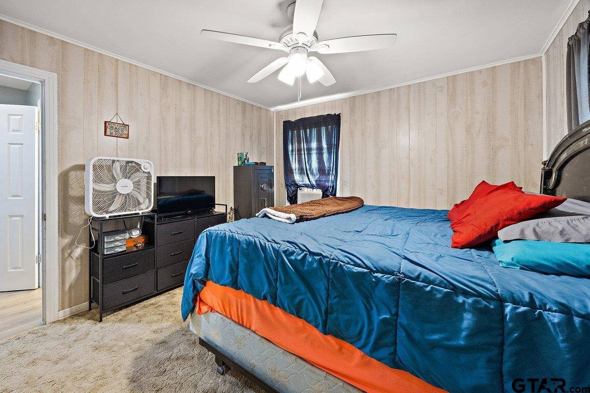 279 Fairview Street Rusk, TX 75785 - Photo 17 of 23 a bedroom with a bed and dresser with mirror