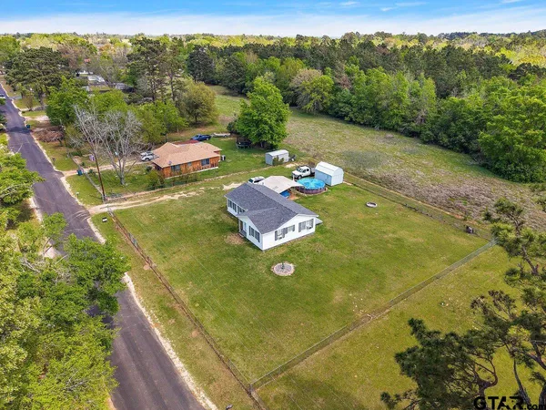 a view of a pool with a yard