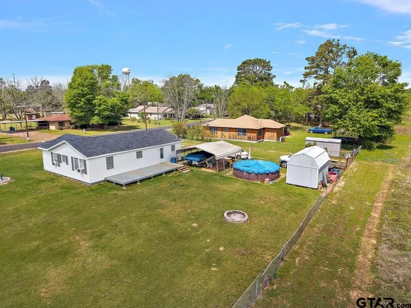 an aerial view of a house with outdoor space swimming pool and mountain view