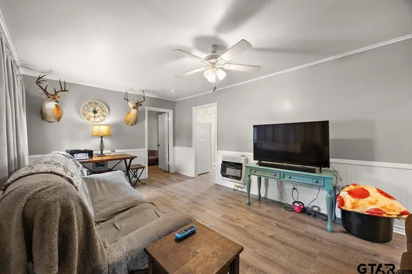 a living room with furniture and a flat screen tv