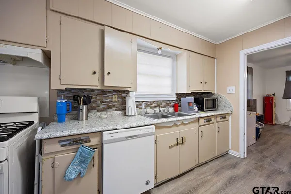 a kitchen with stainless steel appliances granite countertop a sink stove and cabinets