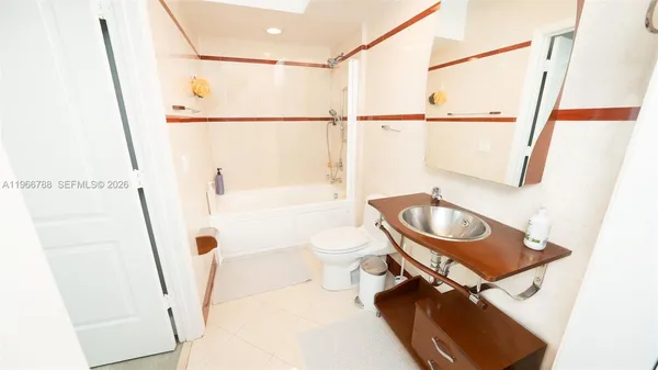 a bathroom with a sink a toilet and a shower