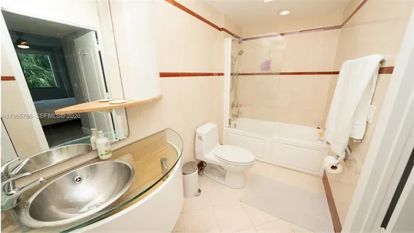 a bathroom with a sink a toilet and a shower