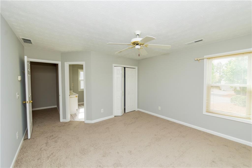 3440 Maple Valley Drive Cumming, GA 30040 - Photo 12 of 23 an empty room with a window and a bathroom