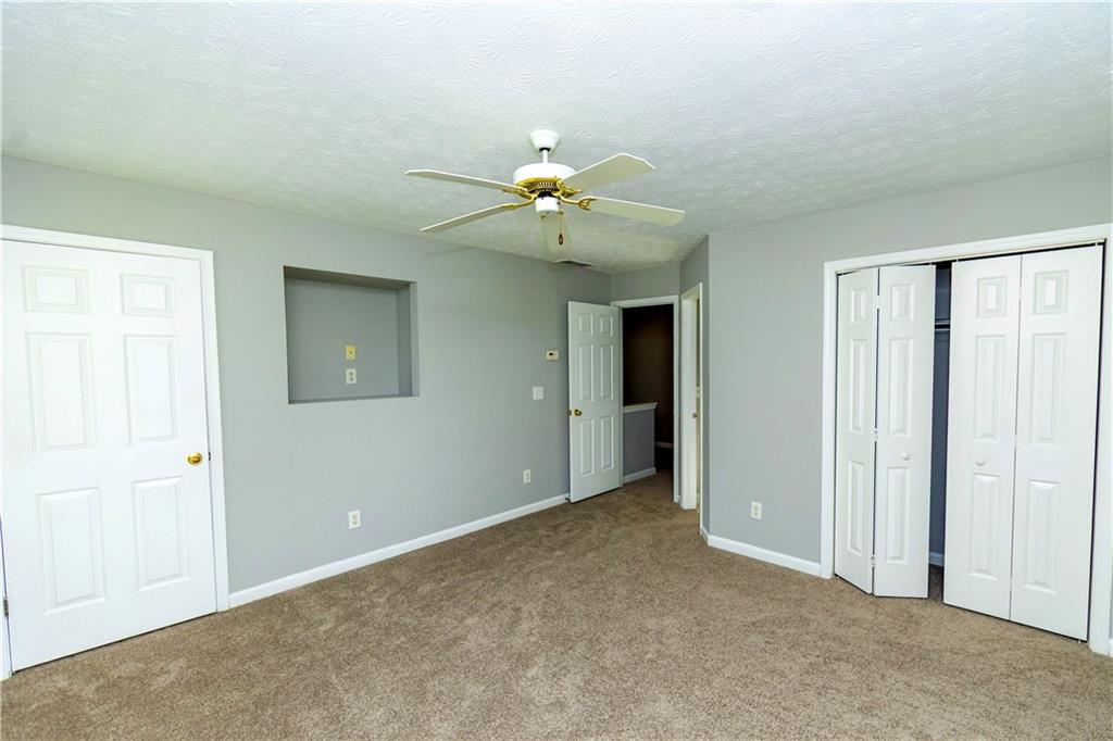 3440 Maple Valley Drive Cumming, GA 30040 - Photo 13 of 23 a view of an empty room with a ceiling fan
