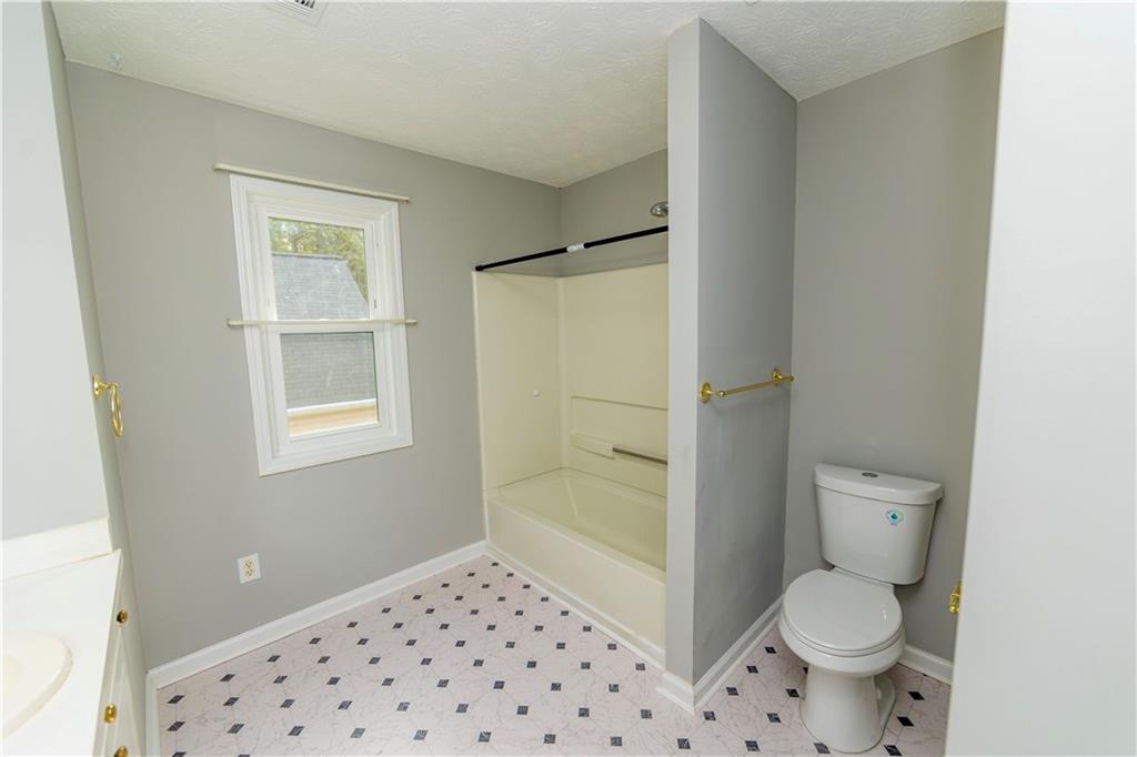 3440 Maple Valley Drive Cumming, GA 30040 - Photo 15 of 23 a bathroom with a toilet and a shower
