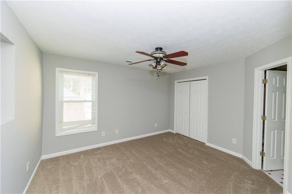 3440 Maple Valley Drive Cumming, GA 30040 - Photo 20 of 23 a view of a room with a ceiling fan and a window