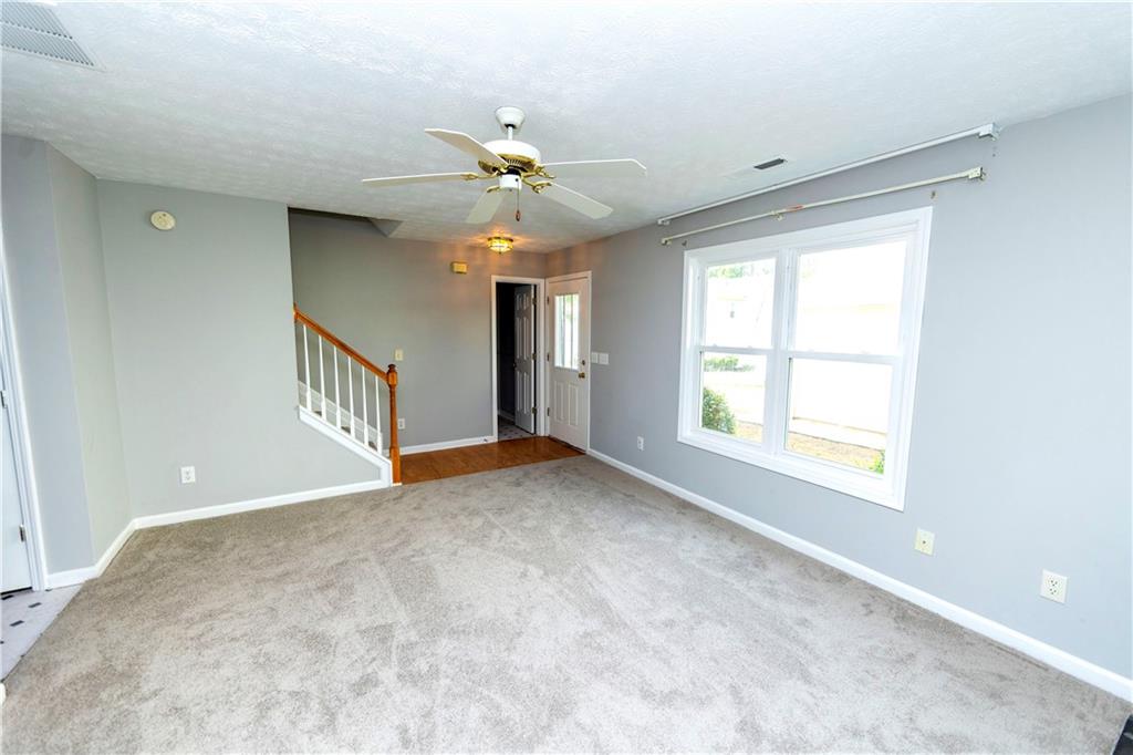 3440 Maple Valley Drive Cumming, GA 30040 - Photo 5 of 23 an empty room with windows and fan