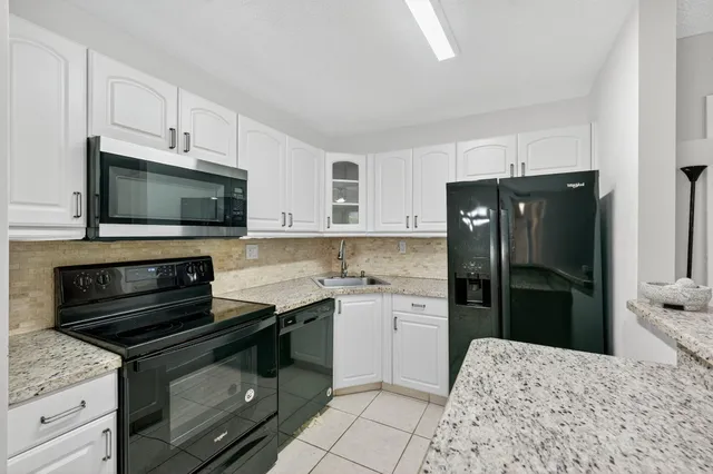 a kitchen with a sink stove and refrigerator
