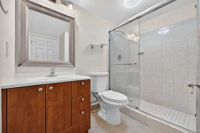 a bathroom with a sink a toilet and shower