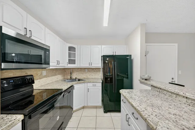 a kitchen with a refrigerator and a sink