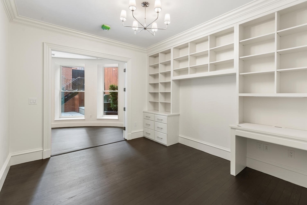 409 Commonwealth Avenue, Unit B Boston, MA 02215 - Photo 30 of 42 a view of an empty room with a window and wooden floor