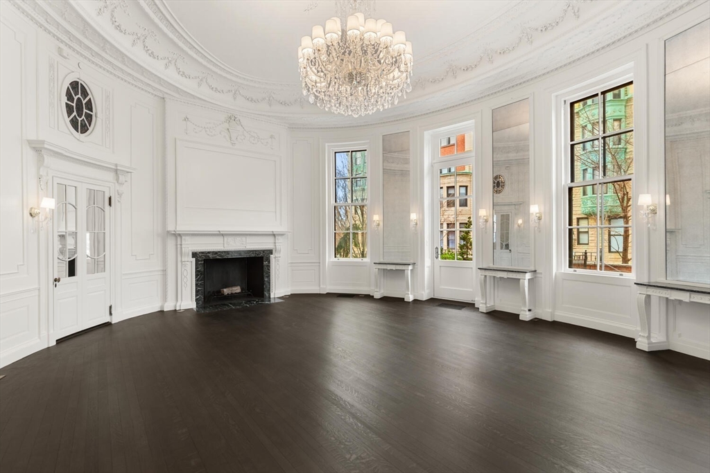 409 Commonwealth Avenue, Unit B Boston, MA 02215 - Photo 3 of 42 a view of an empty room with exposed radiator and fireplace