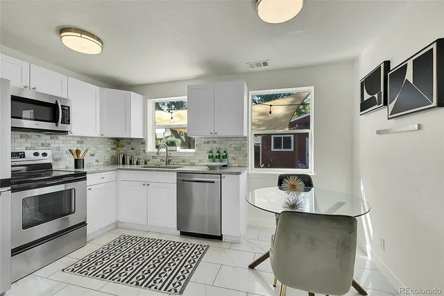 a kitchen with a sink cabinets and stainless steel appliances