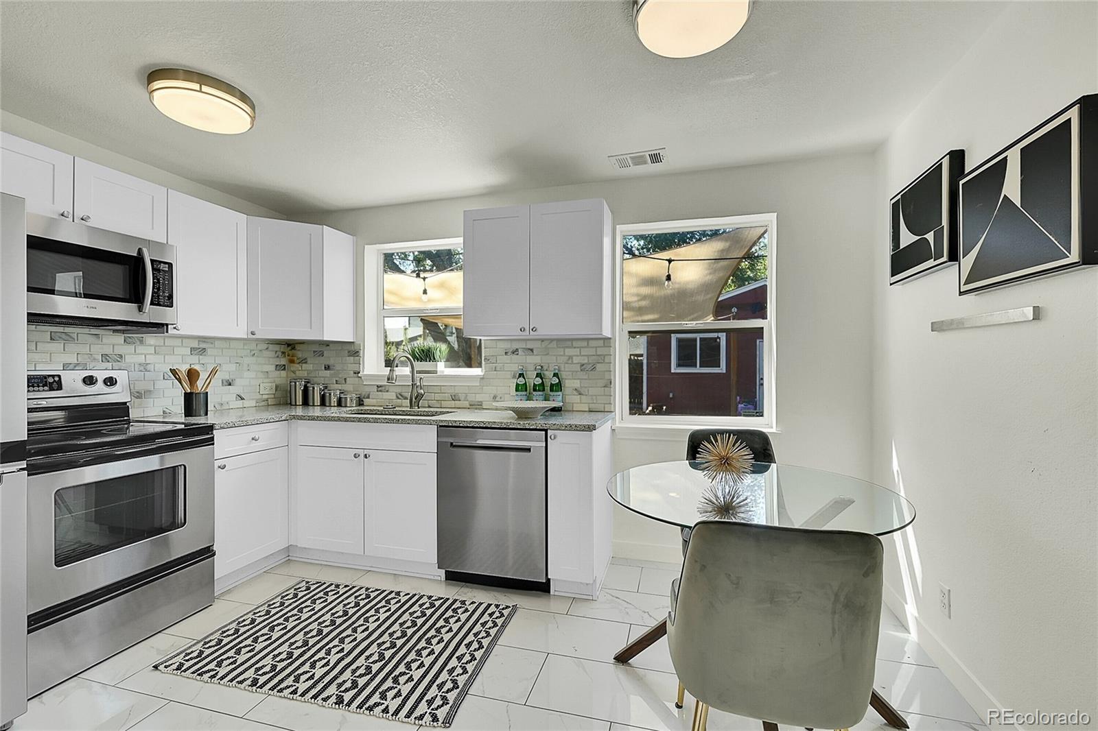 a kitchen with a sink cabinets and stainless steel appliances