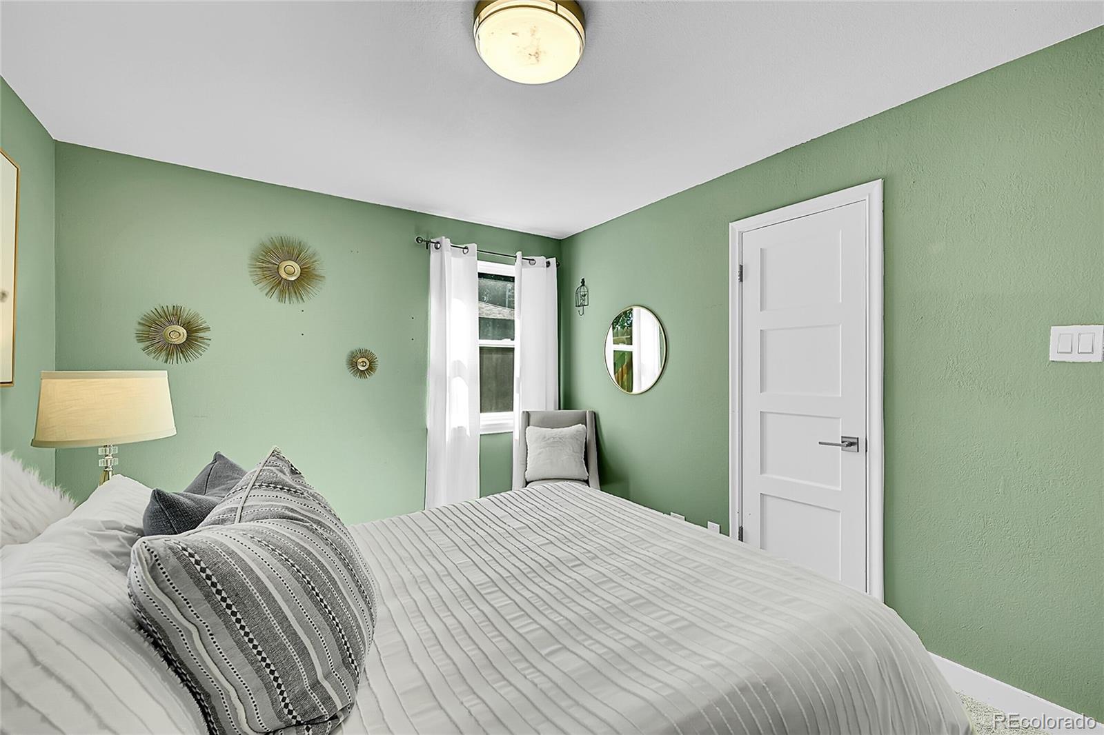 3011 Grape Street Denver, CO 80207 - Photo 12 of 42 a bedroom with a bed and a mirror