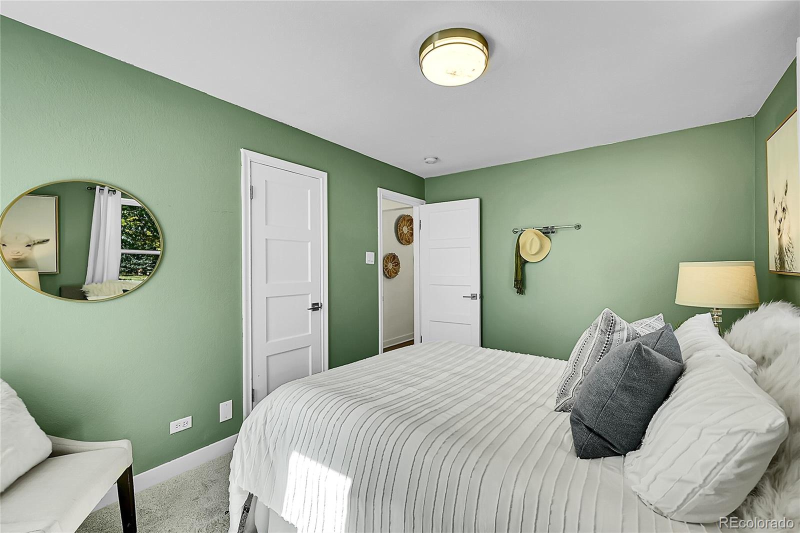 3011 Grape Street Denver, CO 80207 - Photo 15 of 42 a bedroom with a bed and painting on the wall