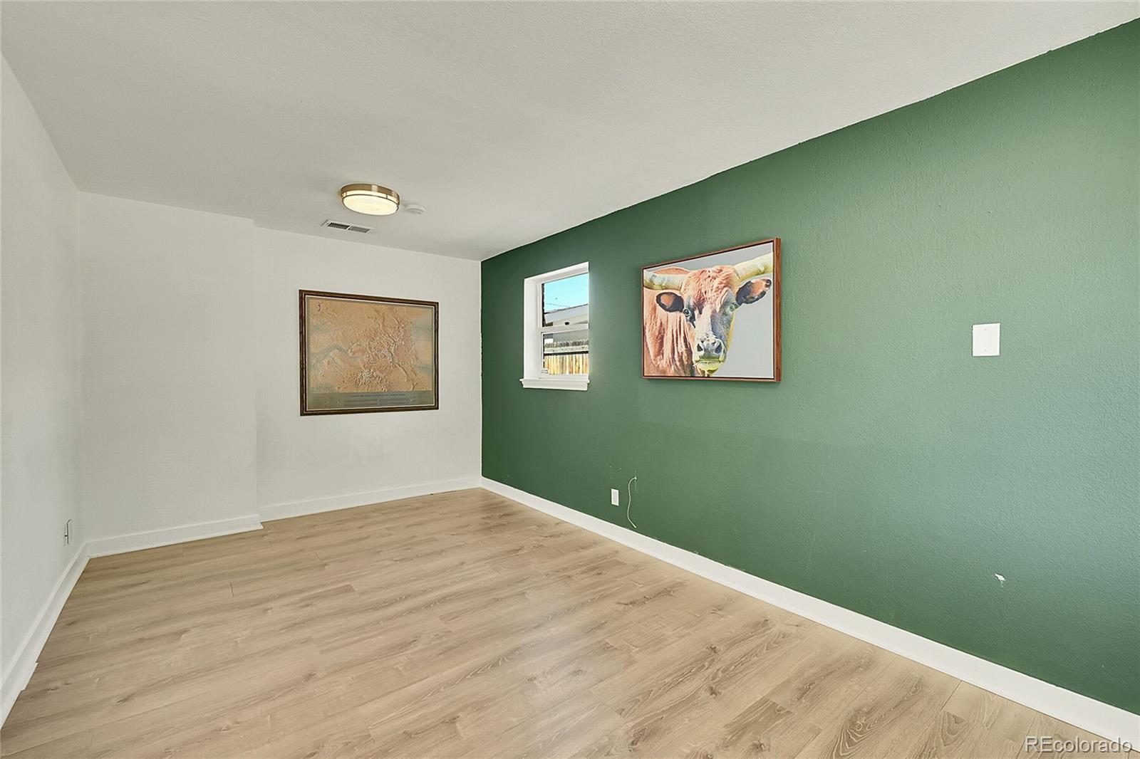 3011 Grape Street Denver, CO 80207 - Photo 17 of 42 a view of room with window and wooden floor