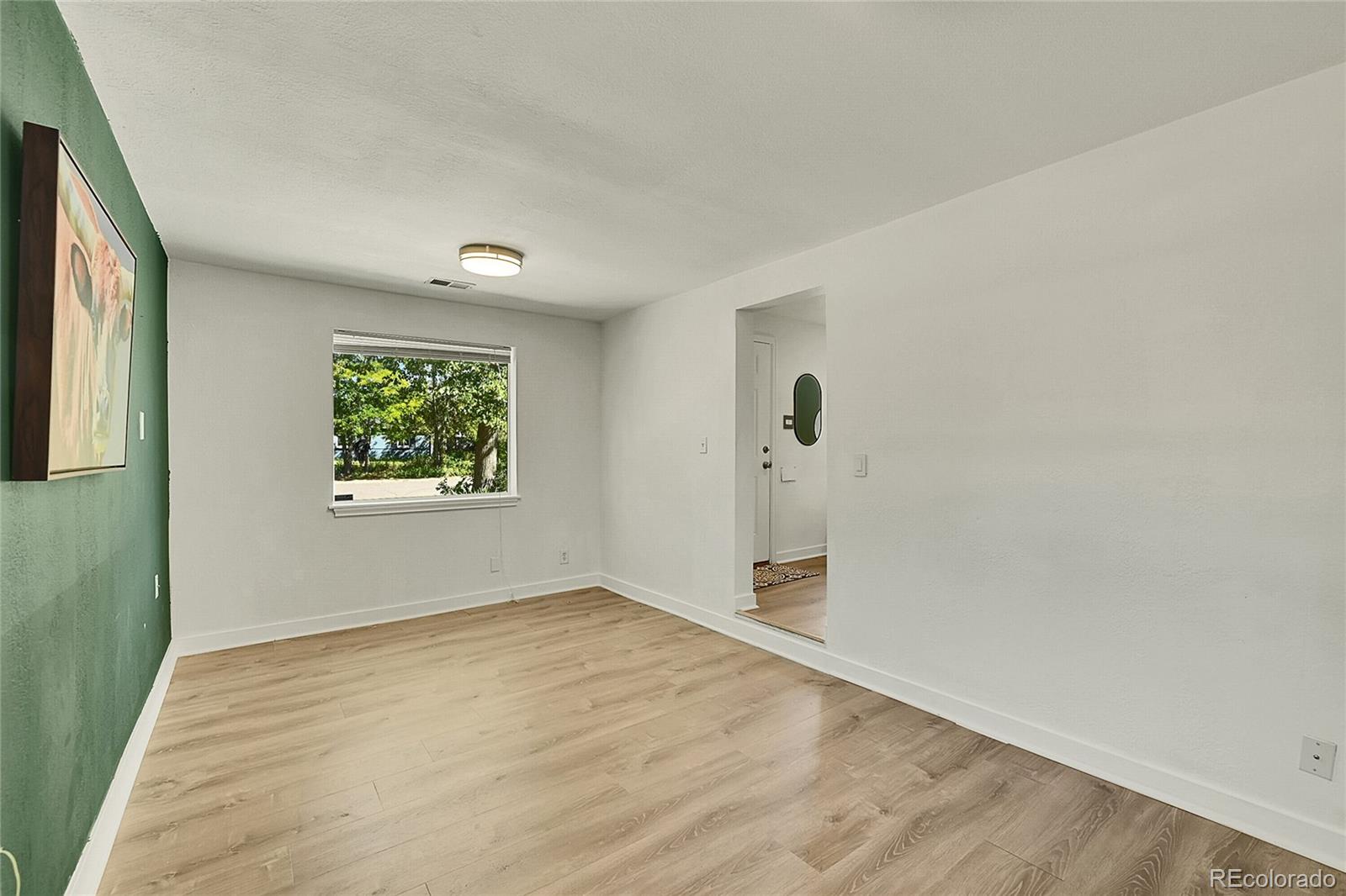 3011 Grape Street Denver, CO 80207 - Photo 19 of 42 an empty room with a window