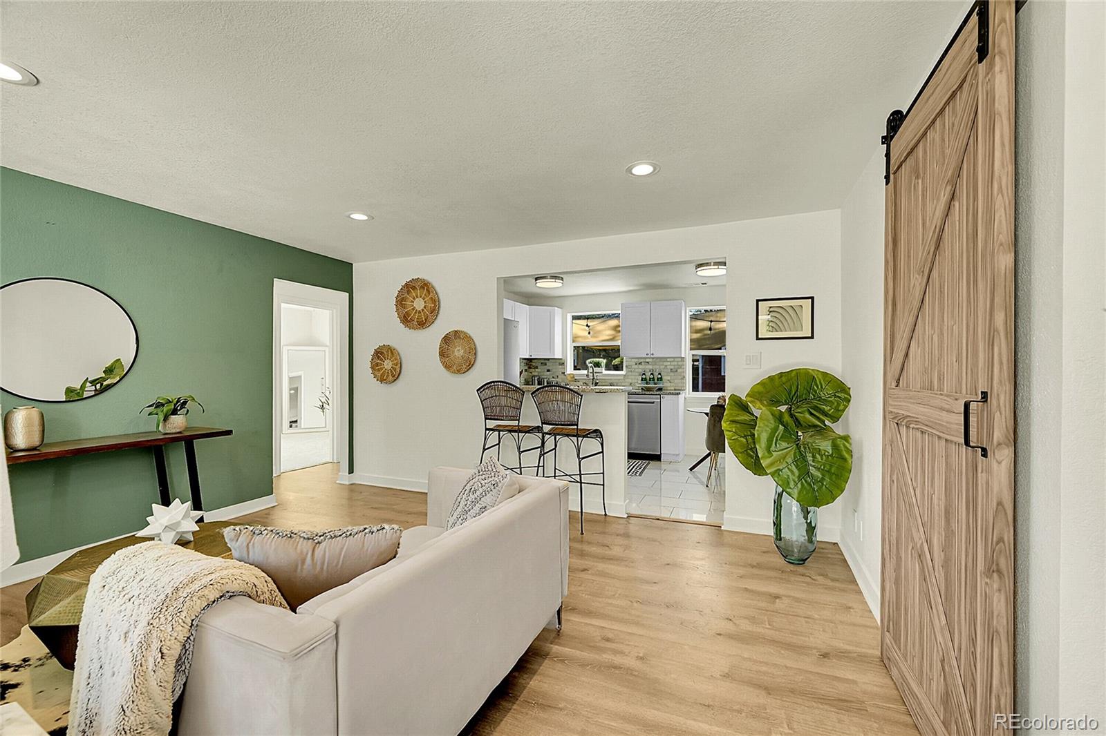 3011 Grape Street Denver, CO 80207 - Photo 2 of 42 a living room with furniture and a wooden floor