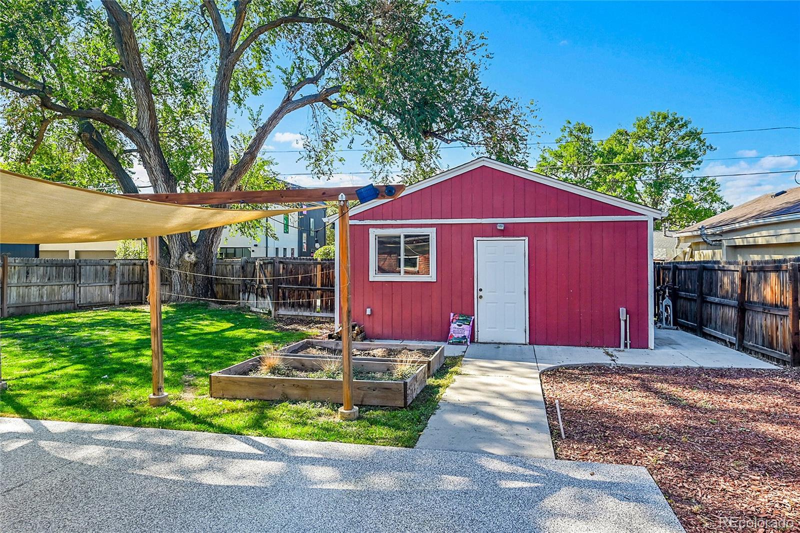 3011 Grape Street Denver, CO 80207 - Photo 25 of 42 a front view of a house with garden