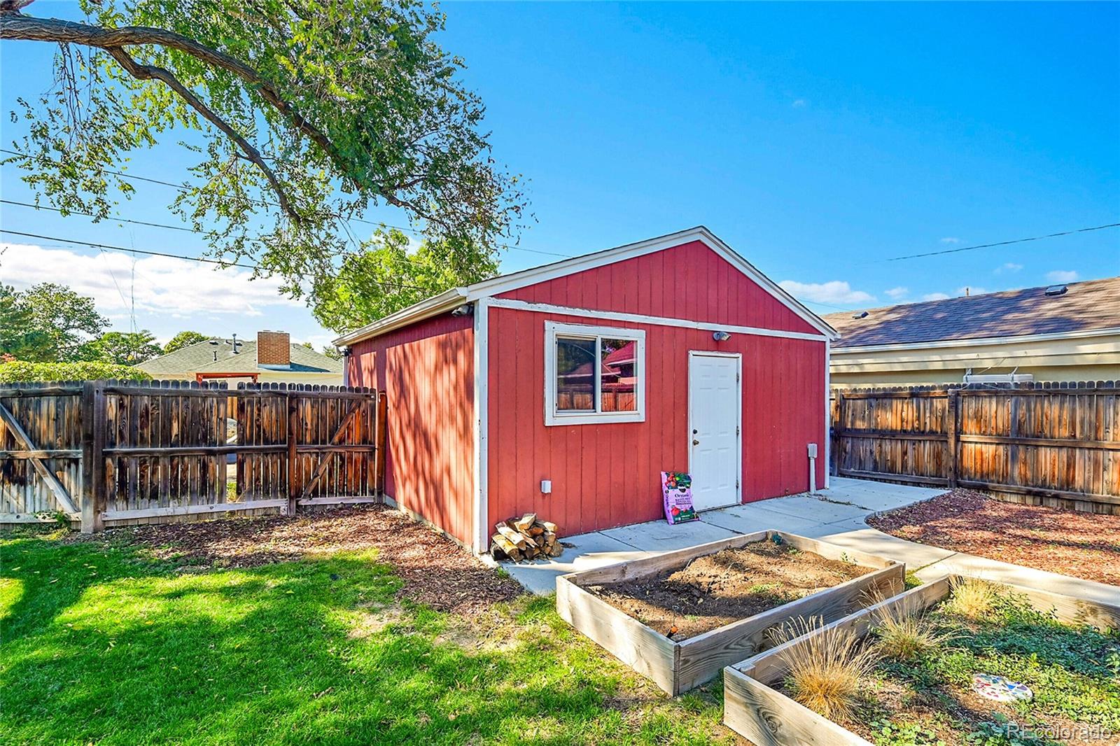 3011 Grape Street Denver, CO 80207 - Photo 27 of 42 a front view of a house with garden