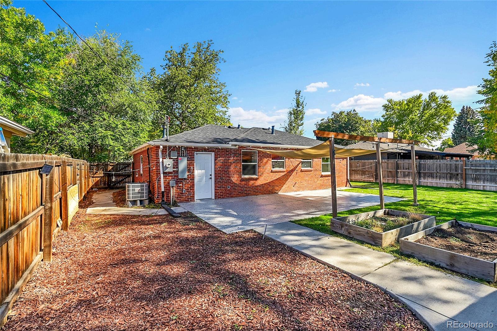 3011 Grape Street Denver, CO 80207 - Photo 28 of 42 a view of a house with backyard and sitting area