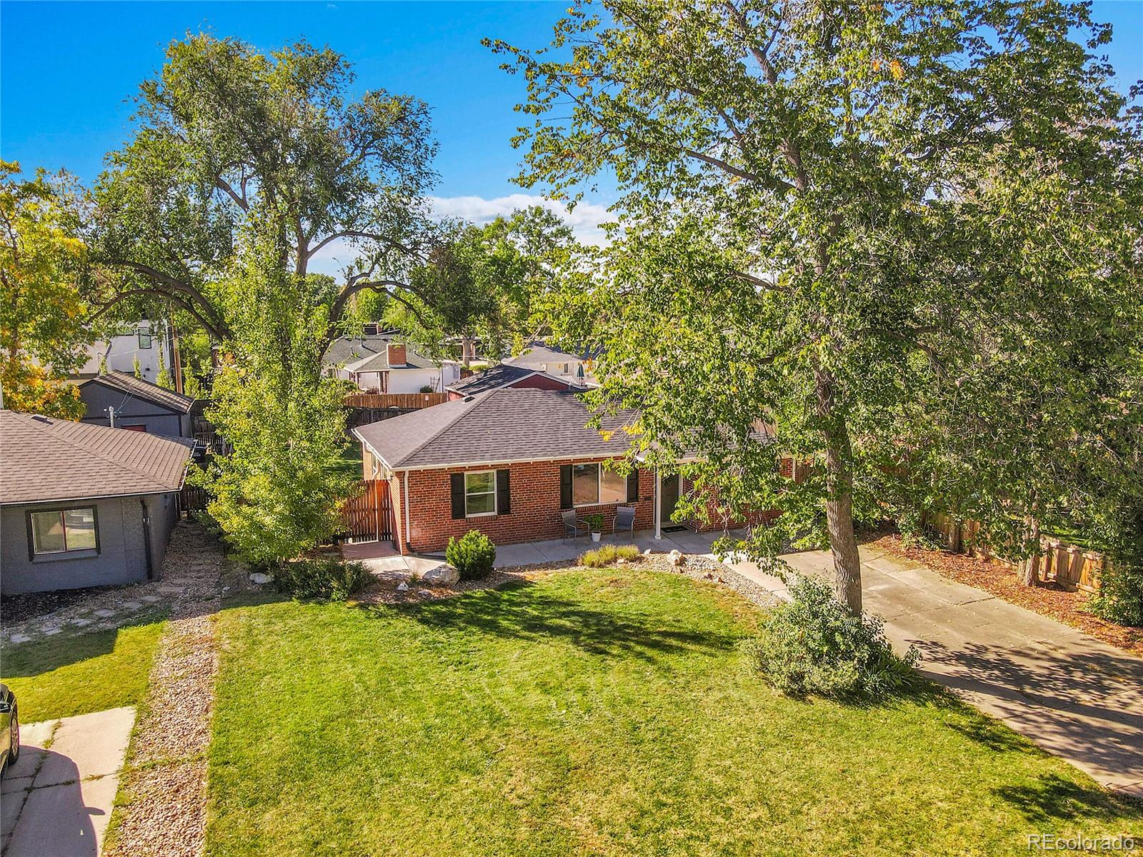3011 Grape Street Denver, CO 80207 - Photo 5 of 42 a front view of a house with a yard