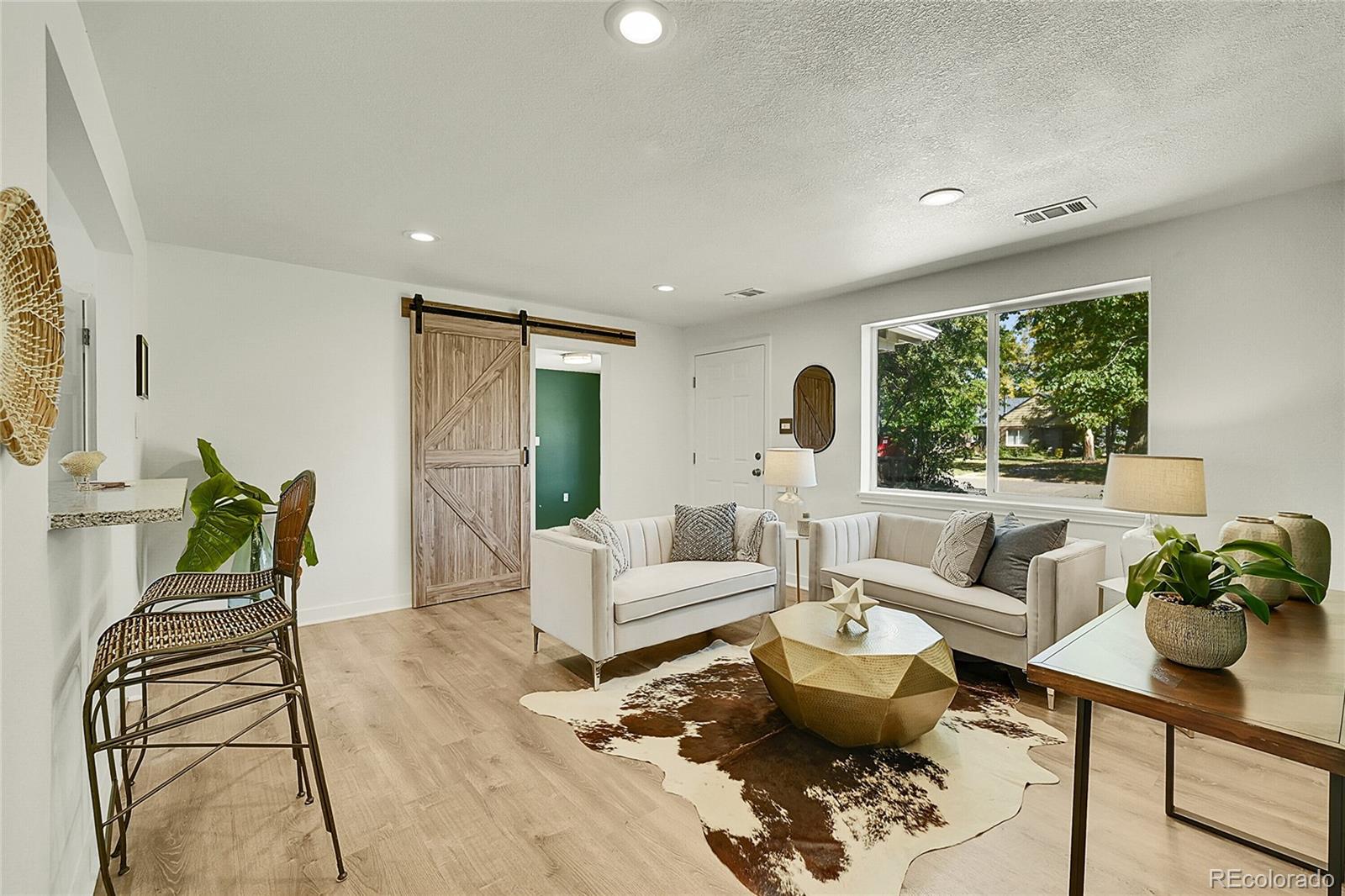 3011 Grape Street Denver, CO 80207 - Photo 7 of 42 a living room with furniture and a large window