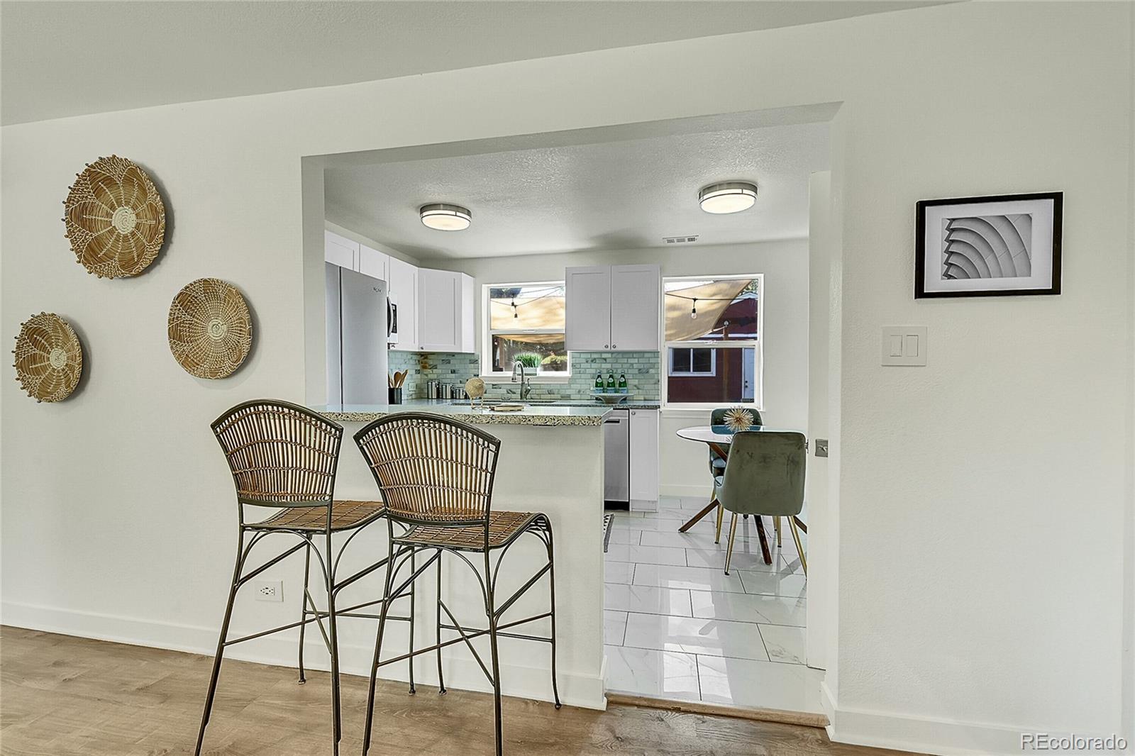 3011 Grape Street Denver, CO 80207 - Photo 8 of 42 a dining room with furniture and a window