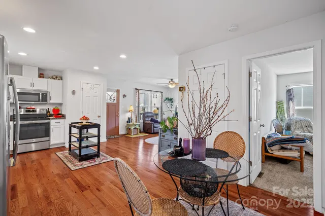 a living room with furniture and kitchen view