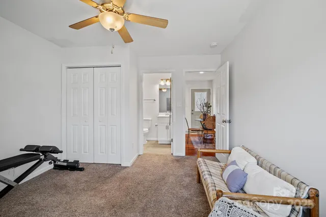a view of a livingroom with furniture and a chandelier fan