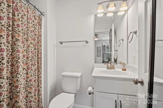 a bathroom with a sink vanity mirror and toilet