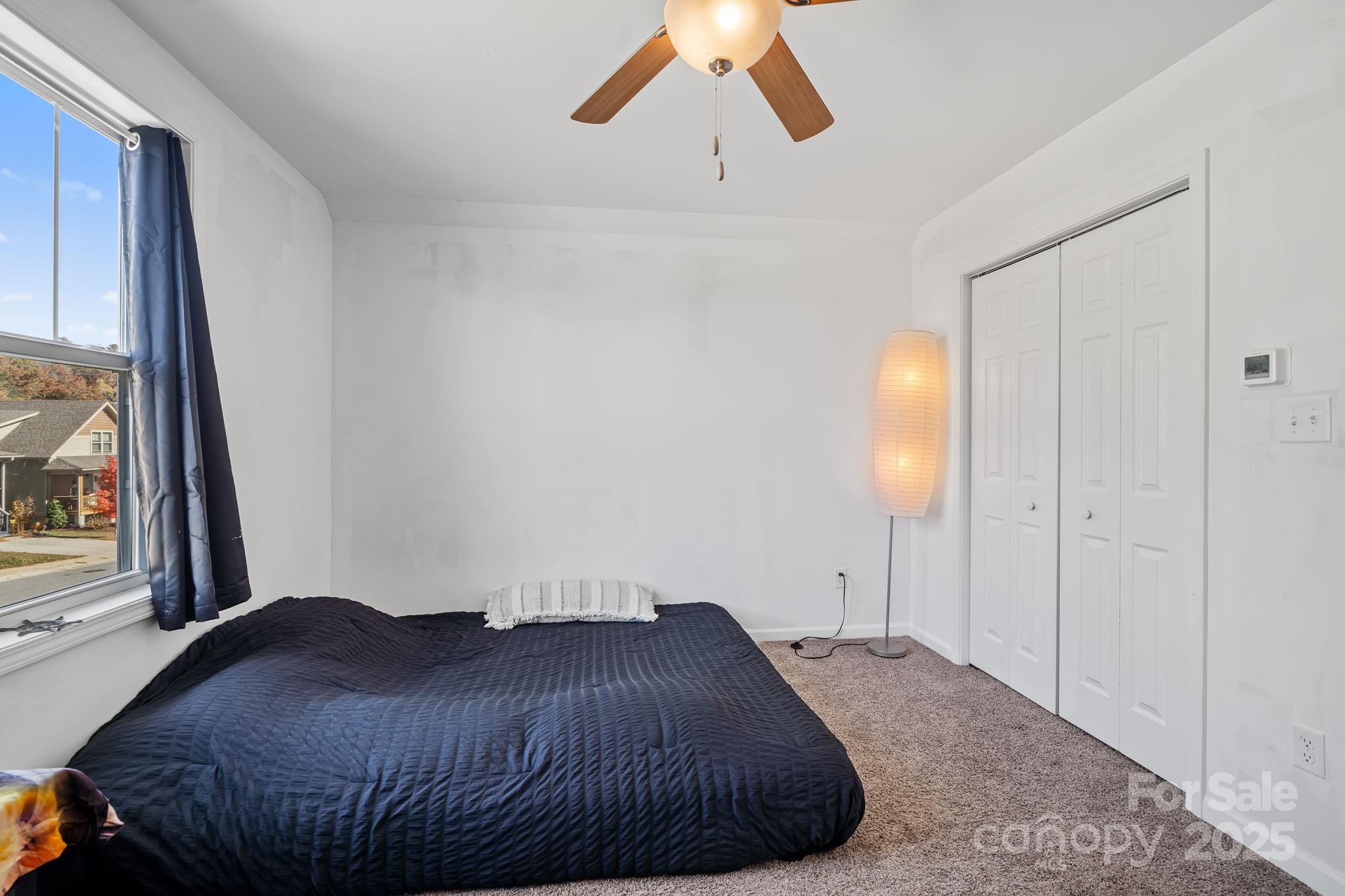 28 Yarrow Meadow Road Weaverville, NC 28787 - Photo 25 of 29 a bedroom with a bed and a large window