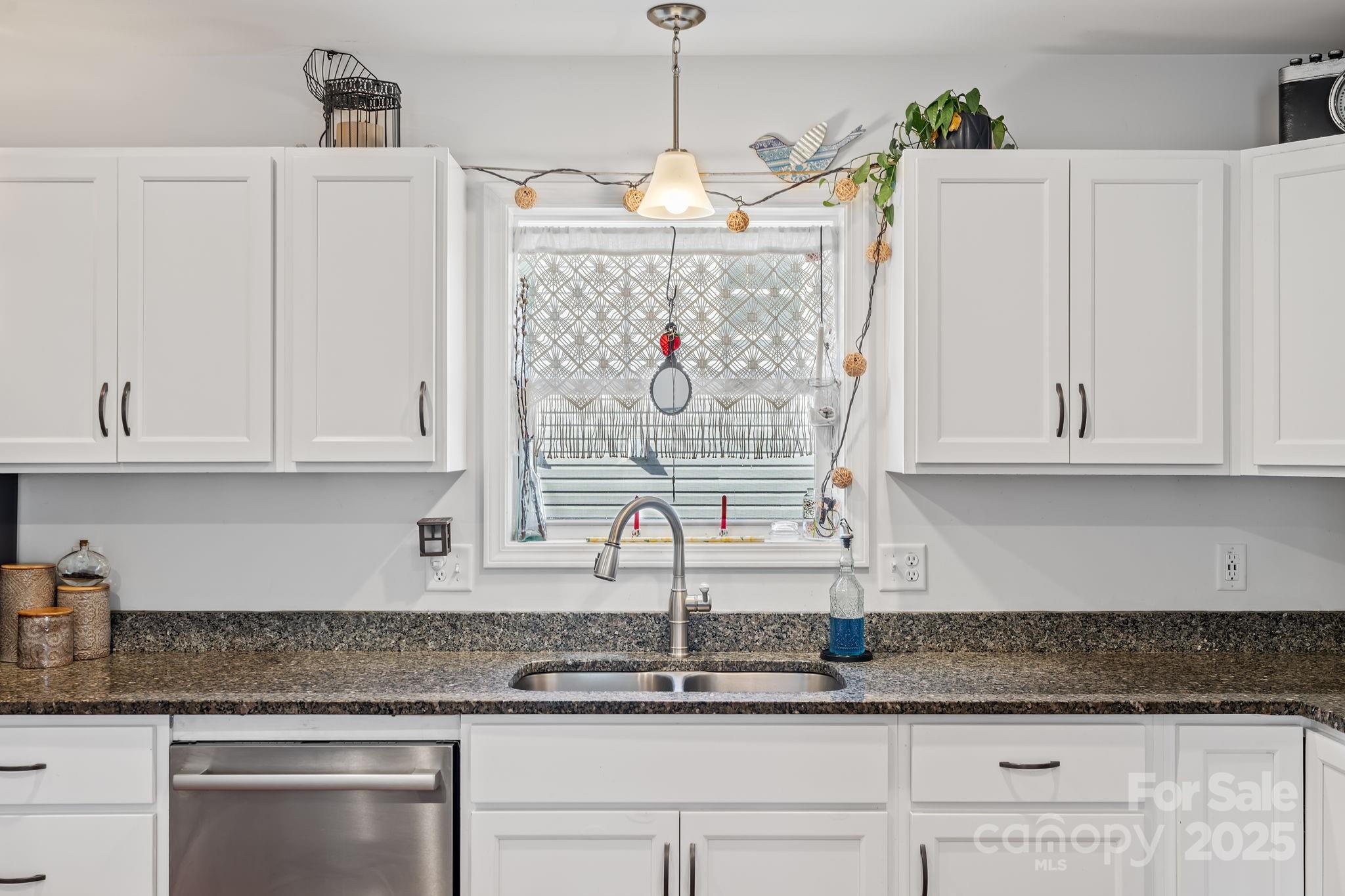 28 Yarrow Meadow Road Weaverville, NC 28787 - Photo 9 of 29 a kitchen with white cabinets and window