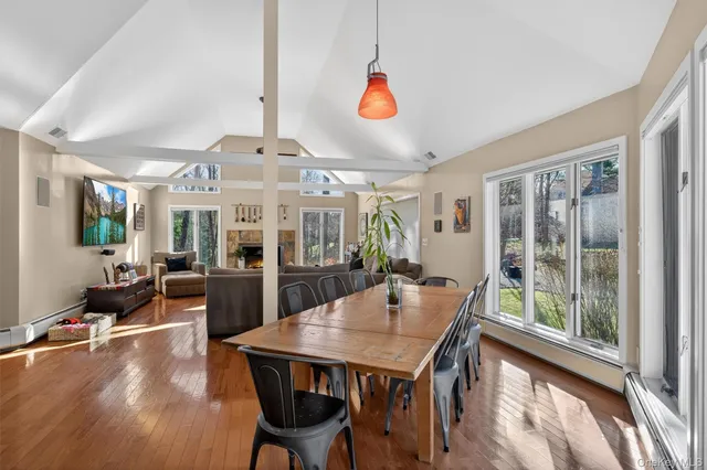 a living room with furniture large window and a fireplace
