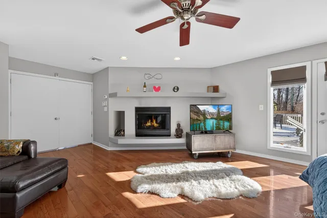 a living room with glass door and furniture