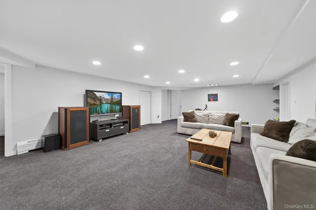 a room with furniture pool table and a window