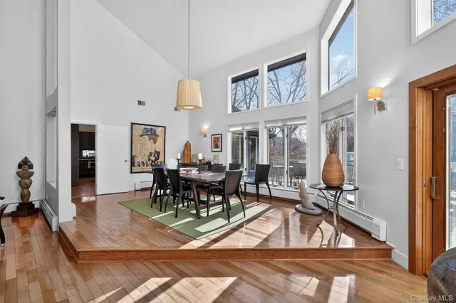 a dining area with furniture window and wooden floor